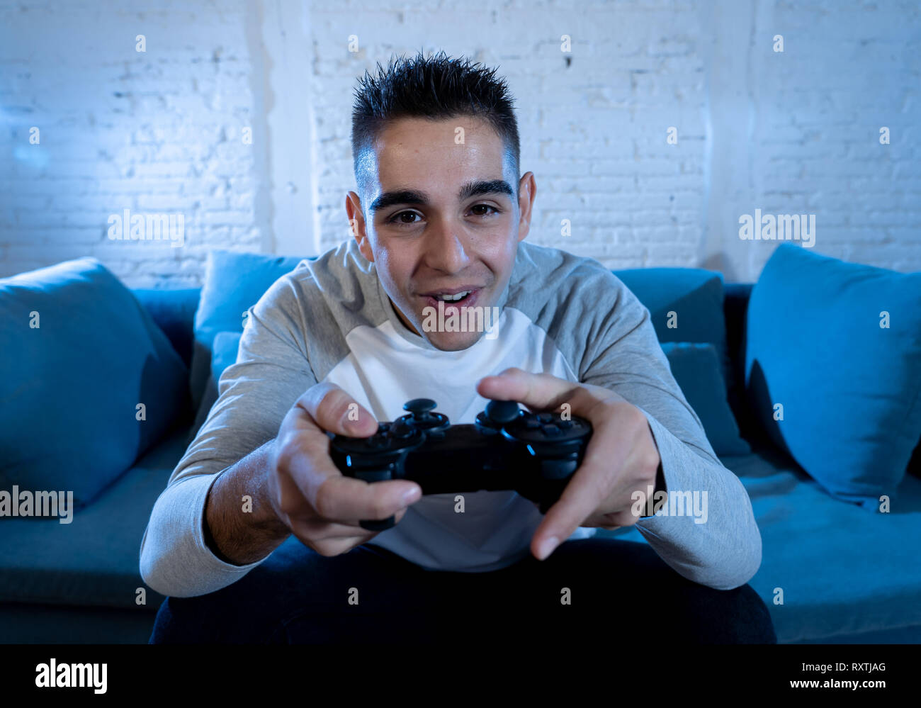 Portrait of young student man playing video games having fun winning the  game using wireless remote joystick with freak intense happy face. In Male  ga Stock Photo - Alamy