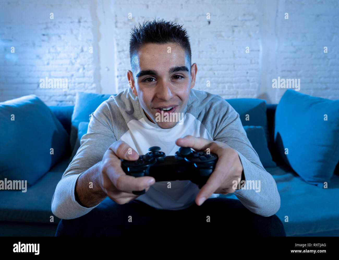 Gamer using controller to play online video games on computer. Man playing  game with joystick and headphones in front of monitor. Player having gaming  equipment, doing fun activity Stock Photo - Alamy