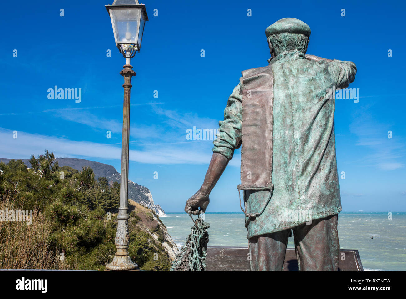 Statue of fisherman guarding the sea -  Numana Sirolo Ancona Marche Italy and Due Sorelle beach. Stock Photo