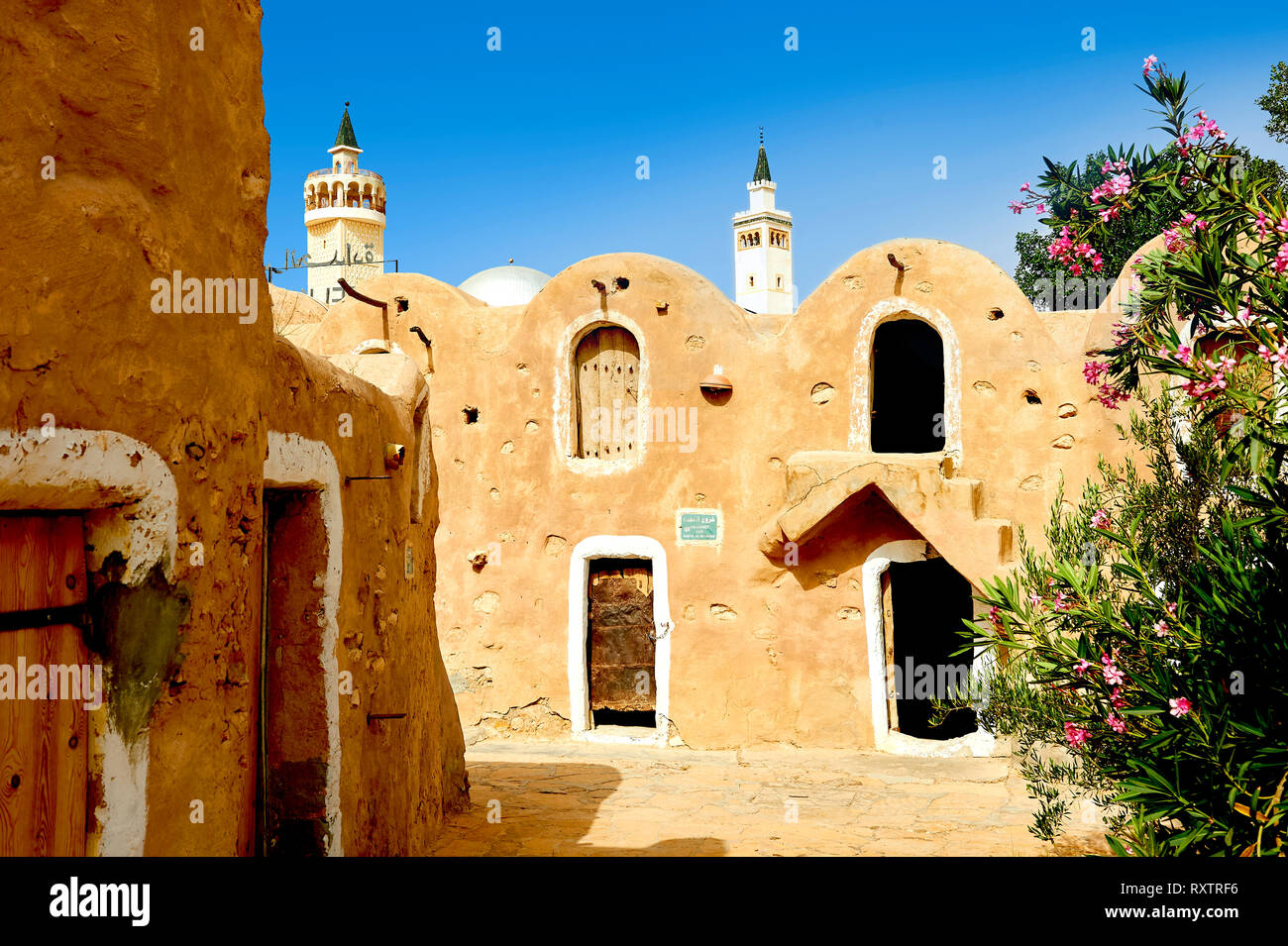 The northern Sahara ghorfa storage graneries of the traditional Berber mud brick fortified Ksar of Hedada or Hadada, near Tetouin, Tunisia, the settin Stock Photo