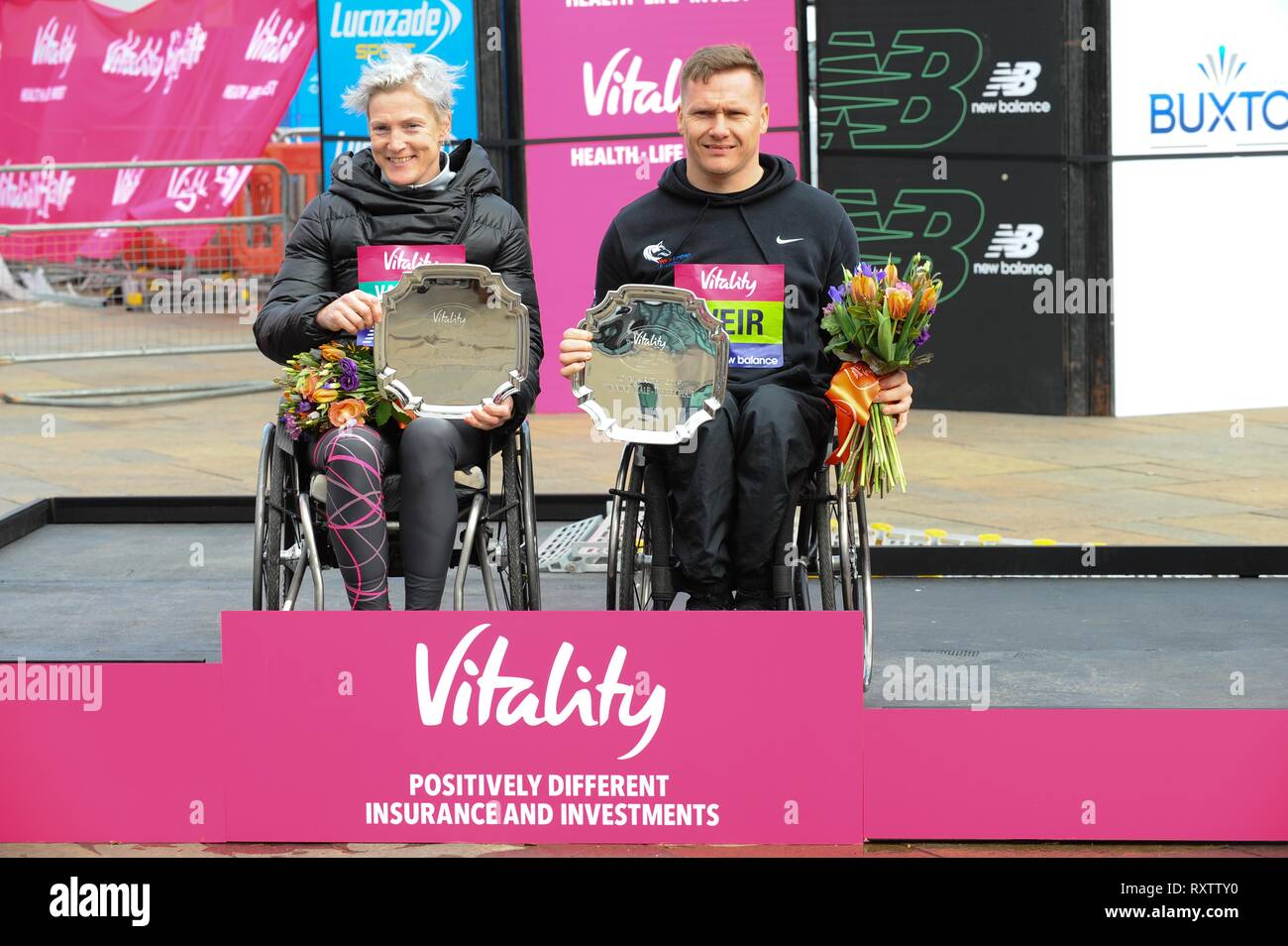 Margaret Van Den Broek and David Weir are seen posing with their awards after running The Vitality Big Half, which has returned for a festival of running and culture to the heart of London in a celebration of the rich and wonderful diversity of the capital city and Finishing it at Cutty Sark. Stock Photo