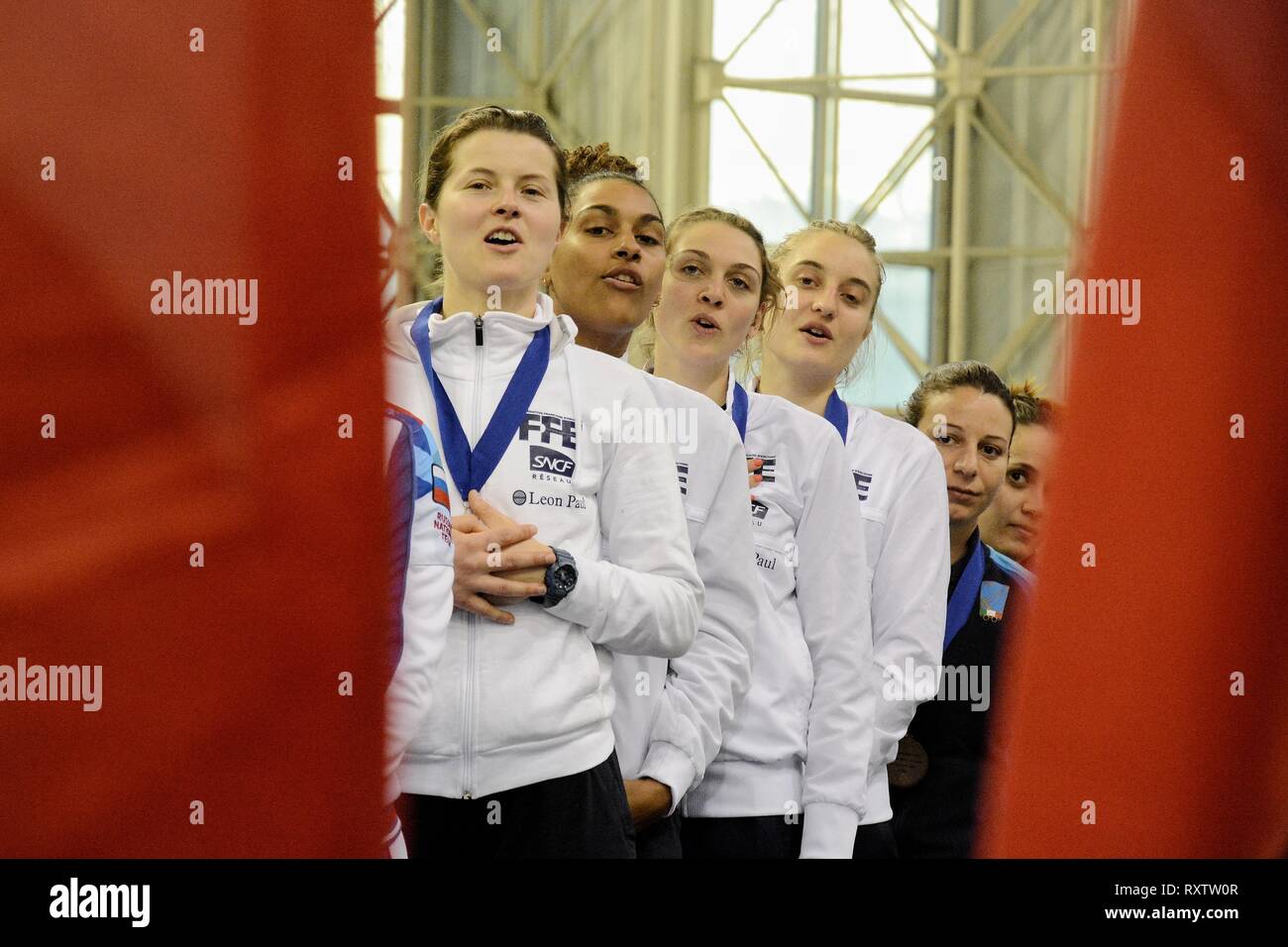 Athletes of Women's fencing team of  France are seen singing the national anthem after winning at the teams final of International fencing tournament Acropolis Coupe 2019. Stock Photo