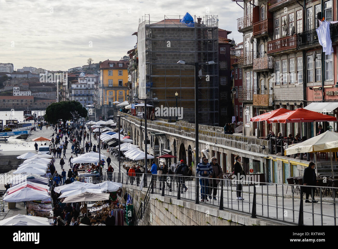 Tourists and locals seen walking with in the historical neighbourhood of Ribeira. In 2018, Porto entered the list of the 100 most visited cities in the world in a ranking prepared by Euromonitor International. In 2018 it is estimated that the number of tourists reached 2.39 million. Stock Photo