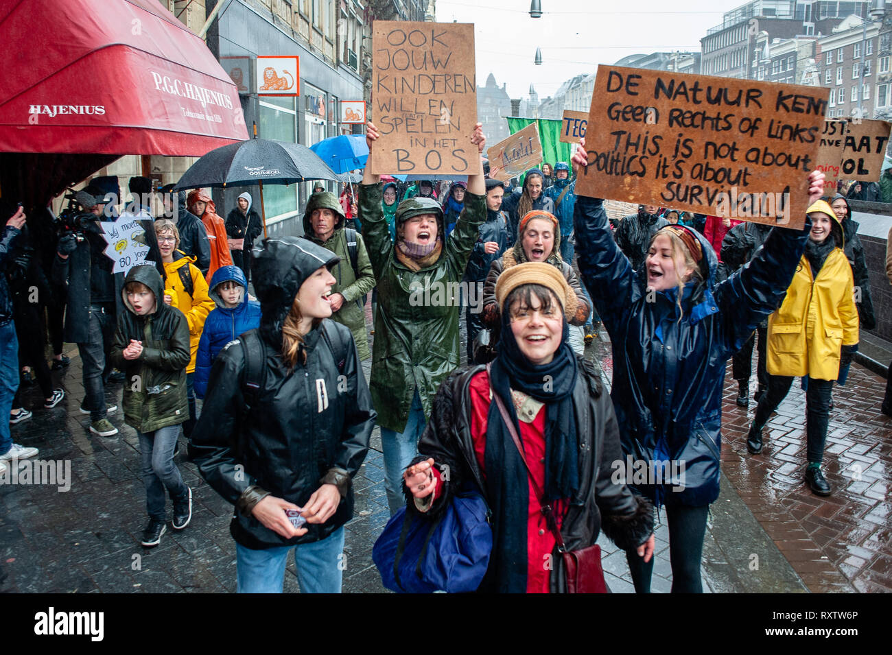 A group of women are seen holding placards while shouting slogans under the rain during the march. The largest climate strike in the Netherlands. This demonstration took place at the Dam square, in the center of Amsterdam. Thousands of people gathered to demand green energy affordable for everyone, big polluters have to pay their fair share, should be a fair distribution of the costs and benefits of the climate transition, and good green jobs. Stock Photo