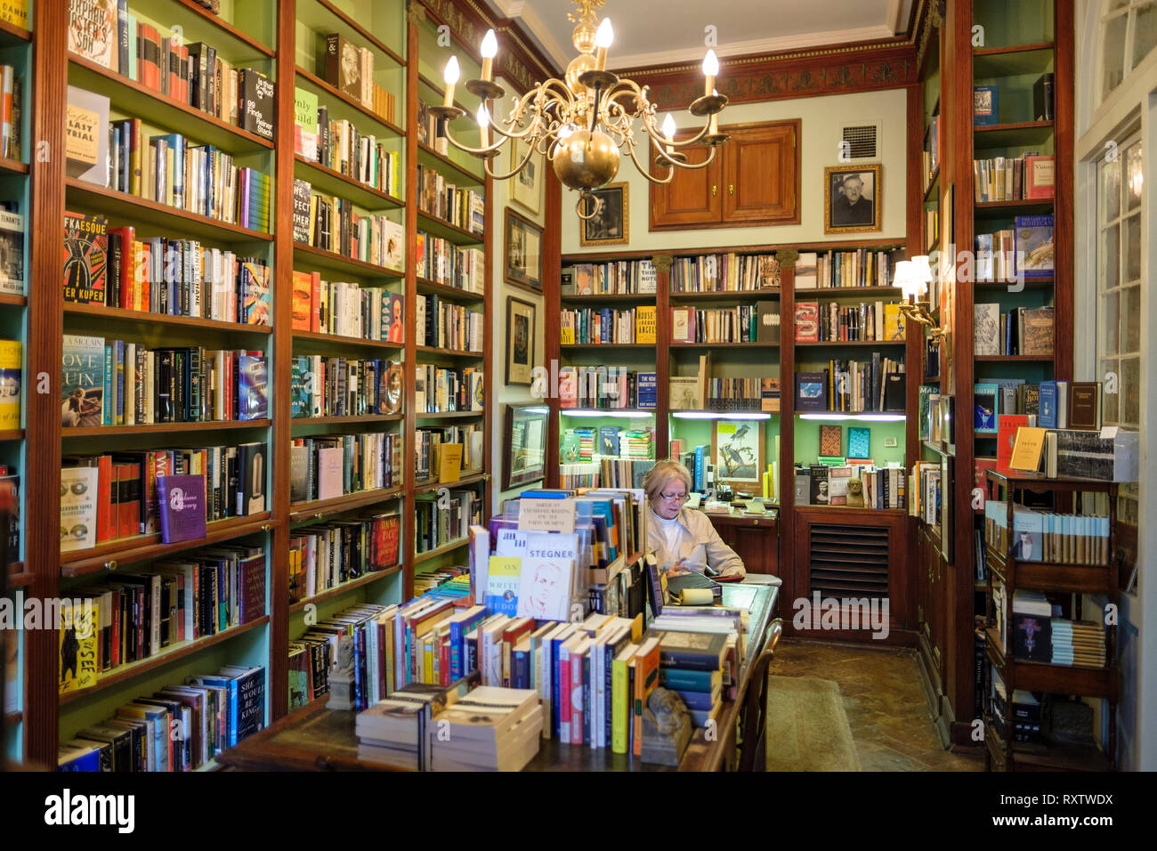 Woman reading, interior of Faulkner House Books, bookstore selling William Faulkner's books, Pirate's Alley, New Orleans French Quarter, New Orleans,  Stock Photo