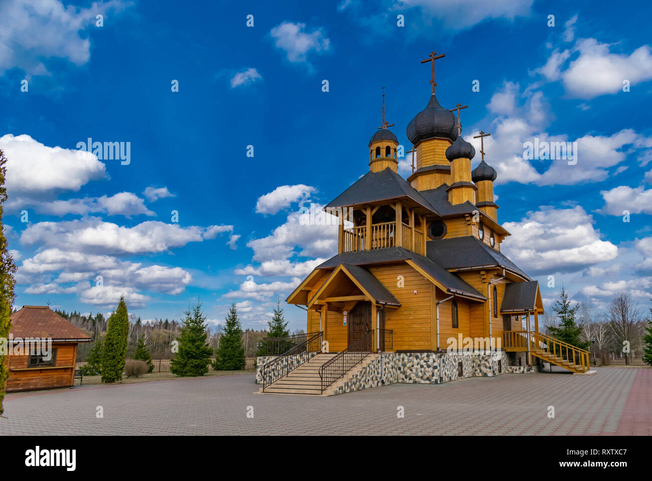 wooden church against the blue sky on a spring day Stock Photo