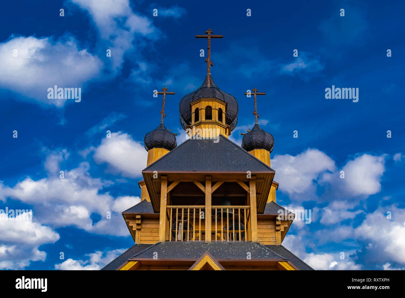 wooden church against the blue sky on a spring day Stock Photo