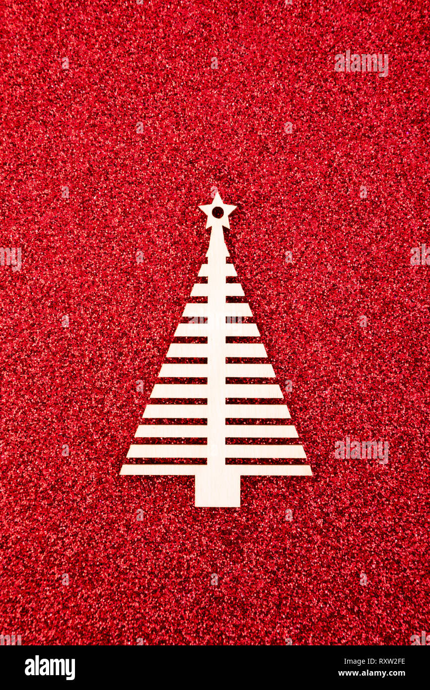 Wooden Christmas tree shape on red glitter background Stock Photo - Alamy