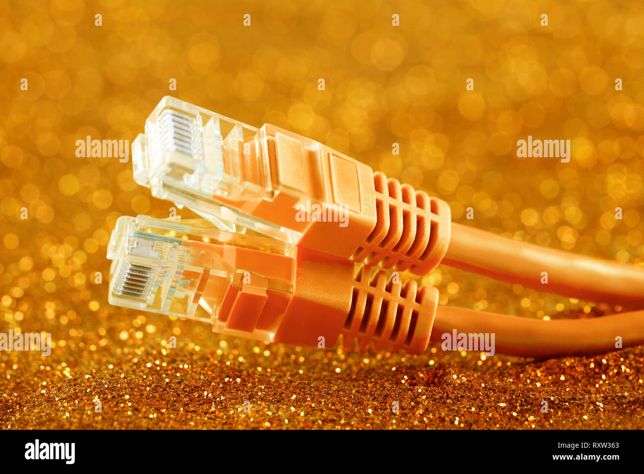 Two network cables over orange sparkles background Stock Photo Alamy