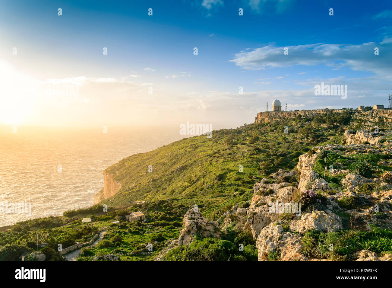 Dingli Cliffs, Malta: Panoramic road with a romantic view over Dingli Cliffs and Aviation radar at sunset Stock Photo