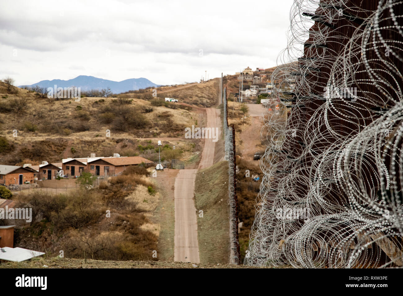 US-Mexico international border: Layers of Concertina are added to existing barrier infrastructure along the U.S. - Mexico border near Nogales, AZ, on February 4, 2019. See more information below. Stock Photo
