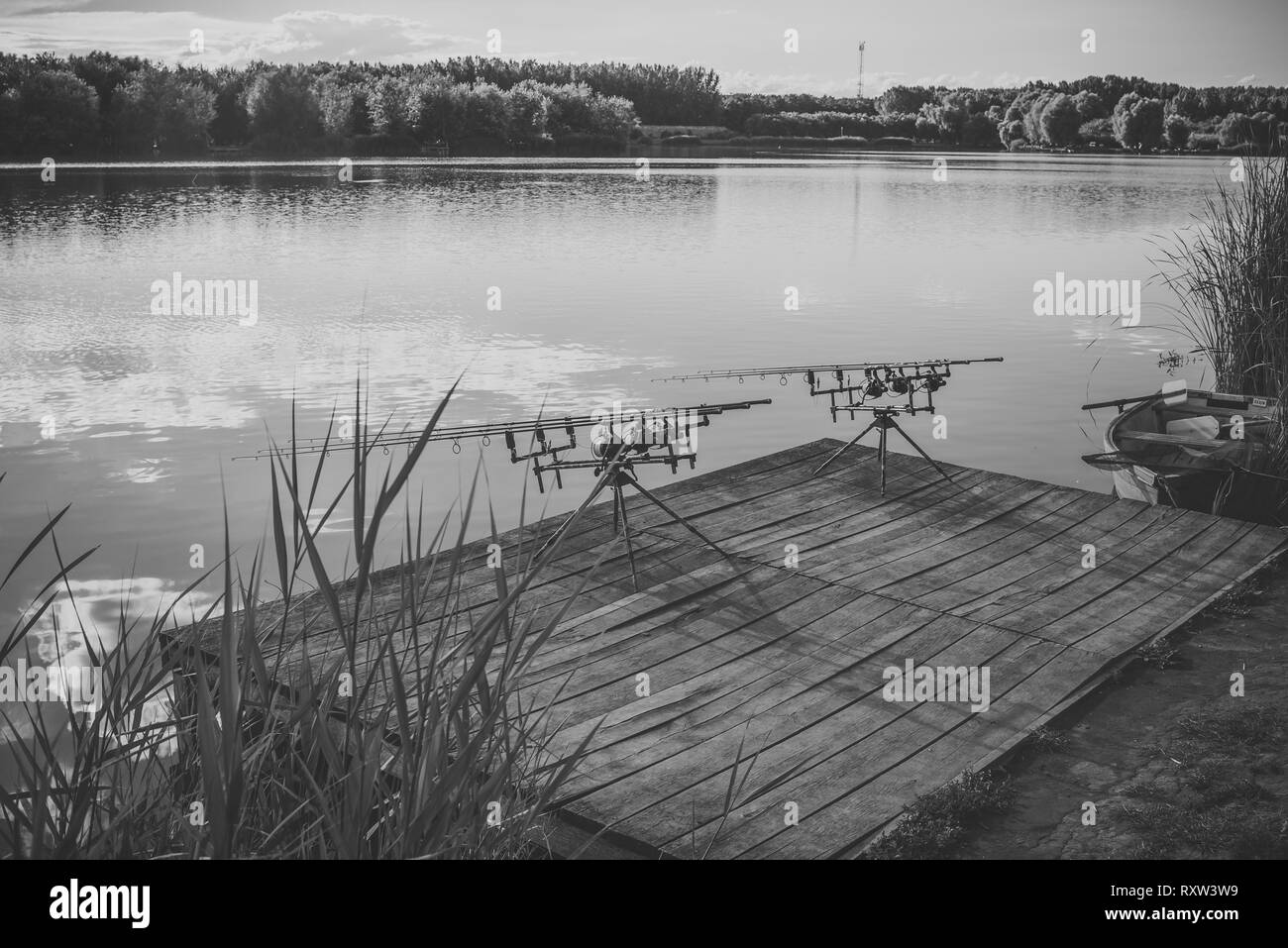 Fishing rods on wooden pier Stock Photo