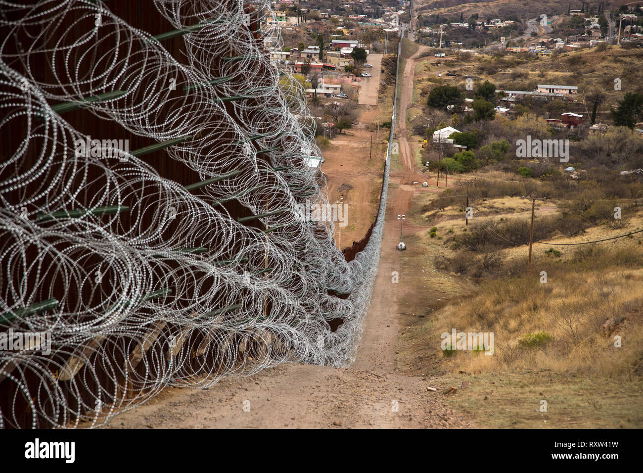 US-Mexico international border: Layers of Concertina are added to existing barrier infrastructure along the U.S. - Mexico border near Nogales, AZ, on February 4, 2019. See more information below. Stock Photo