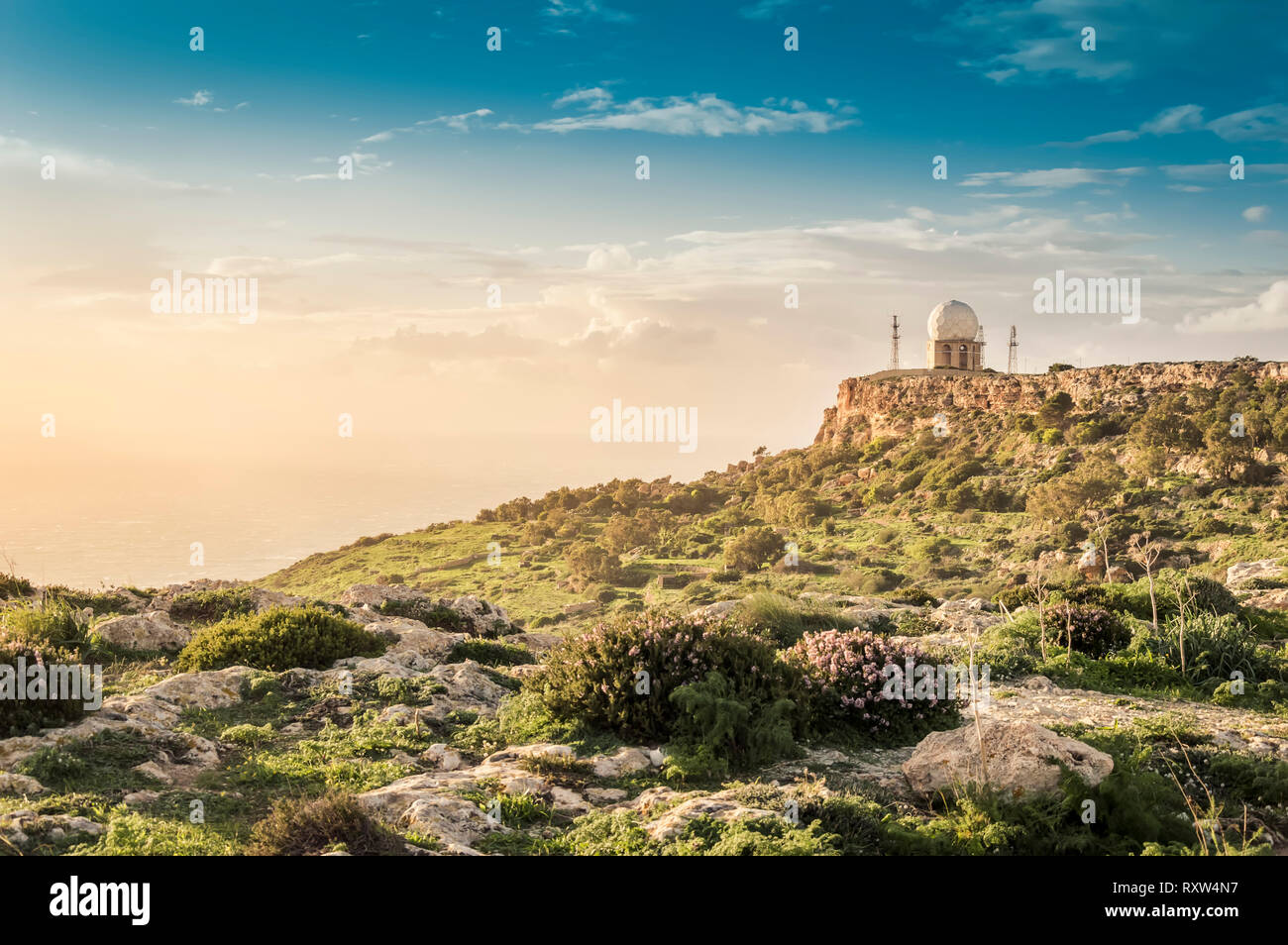 Dingli Cliffs, Malta: Panoramic road with a romantic view over Dingli Cliffs and Aviation radar at sunset Stock Photo