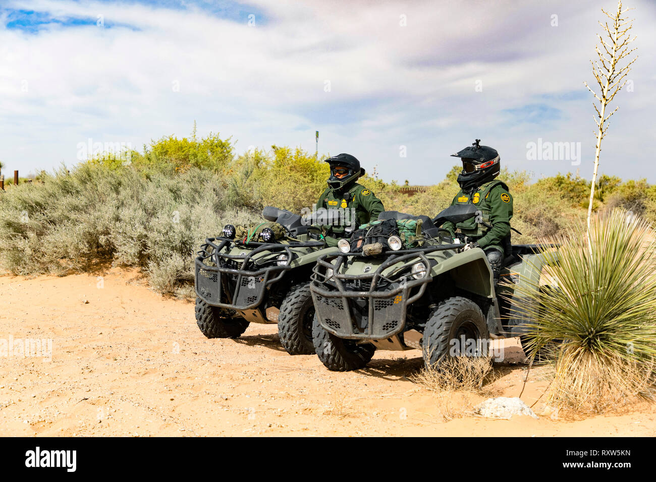 United States Customs and Border Protection (USCBP) officers guard the US-Mexico international border near the Santa Teresa Port of Entry in New Mexico on quad bikes. See more information below. Stock Photo