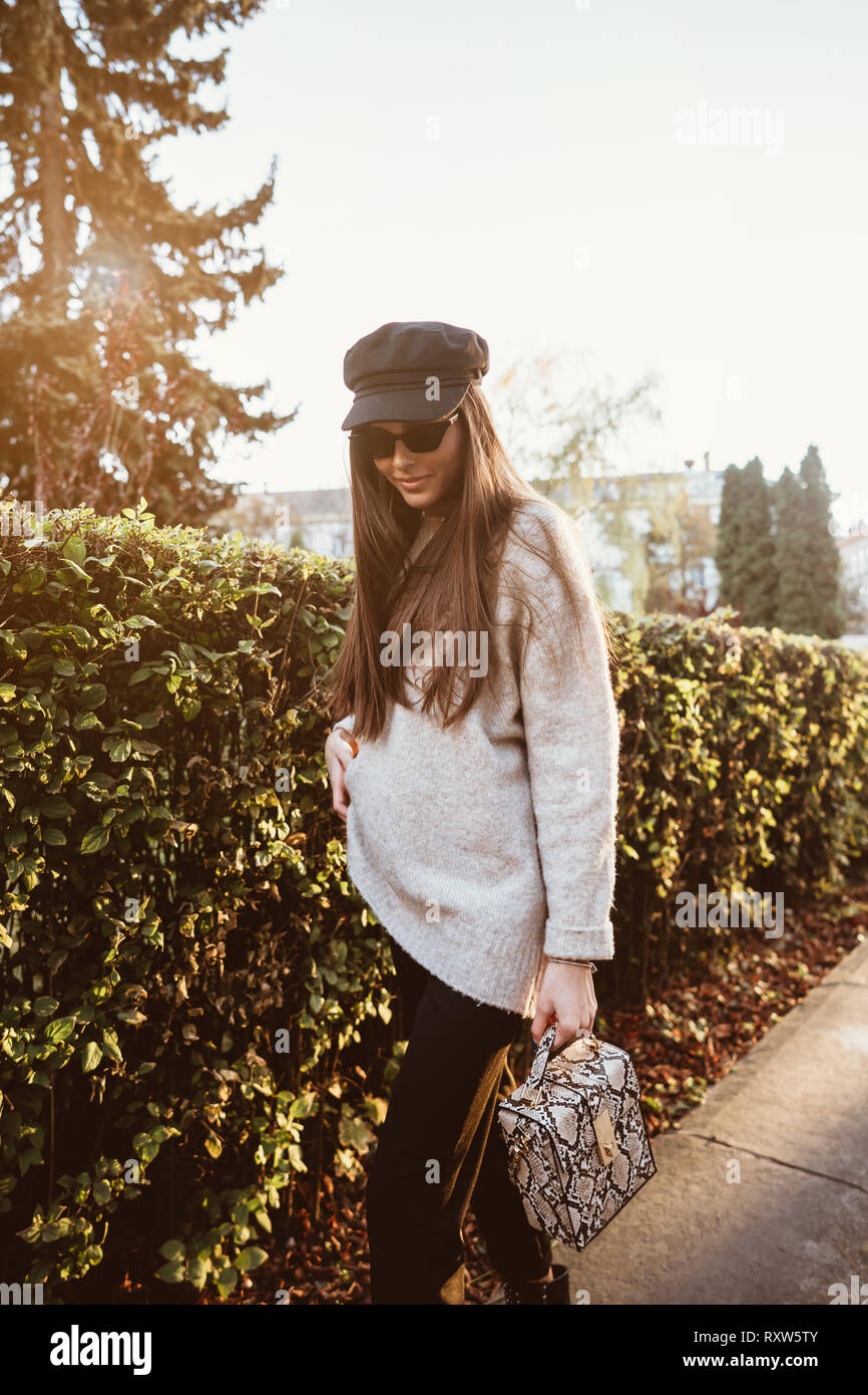 Beautiful young woman posing in the park near the hedge Stock Photo - Alamy