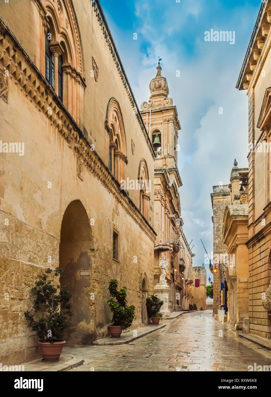 Mdina, Malta: Church of the Annunciation of Our Lady in narrow sett street of medieval town with lantern lights. Medieval Maltese architecture Stock Photo