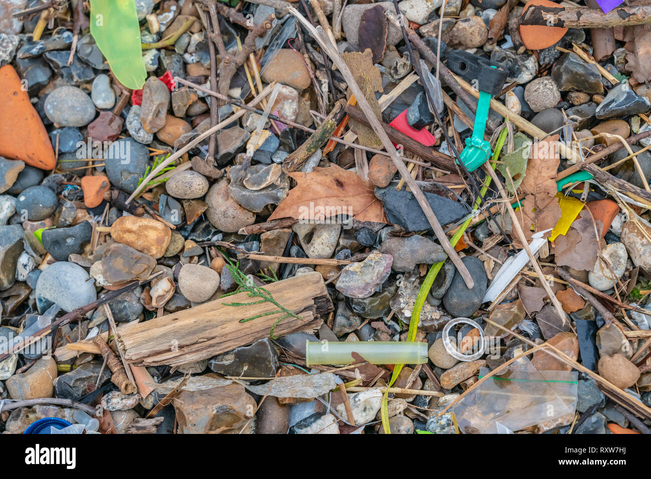 Spilled garbage on the beach of the big city. The accumulation of plastic objects in the Earth's environment adversely affects wildlife and humans. Stock Photo