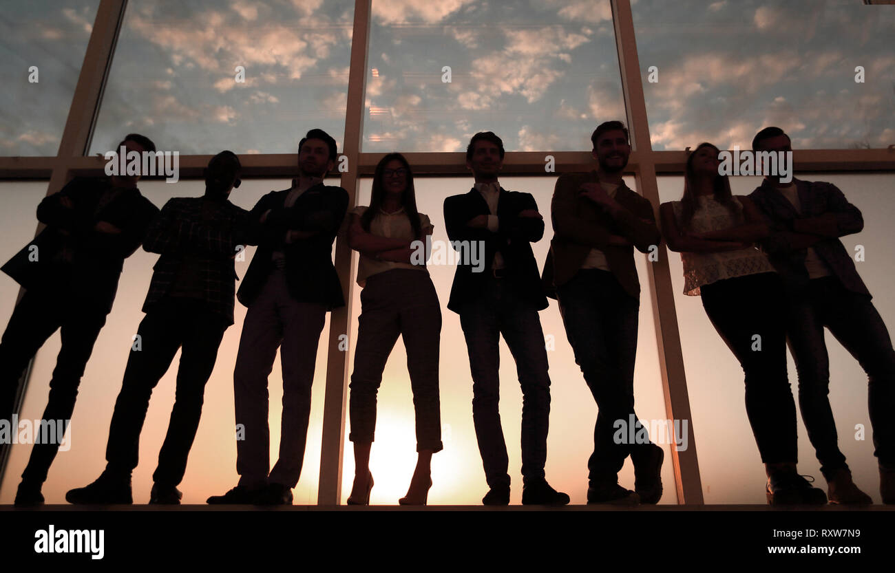 in full growth. business team standing near the office window Stock Photo