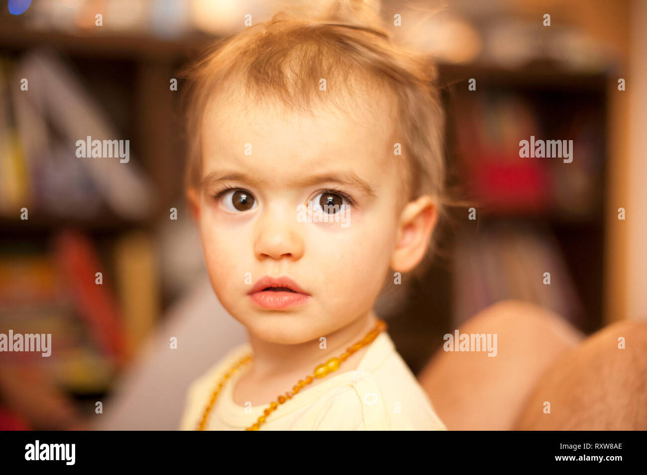 Portrait of blonde baby girl with beautiful brown eyes Stock Photo