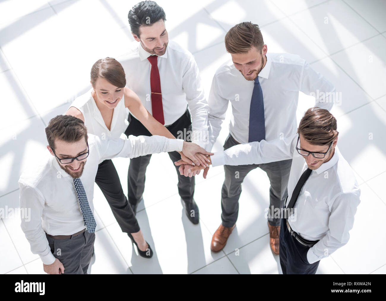 Employees office pile hands hi-res stock photography and images - Alamy