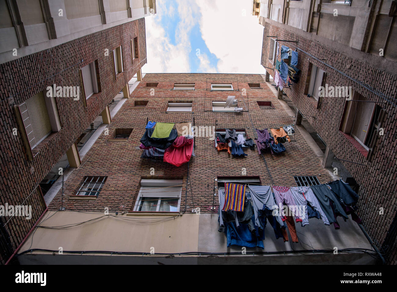 Looking up at Laundry on Drying Racks Outside the Windows of Apartments in  the old district of Barceloneta, Barcelona, Spain Stock Photo - Alamy