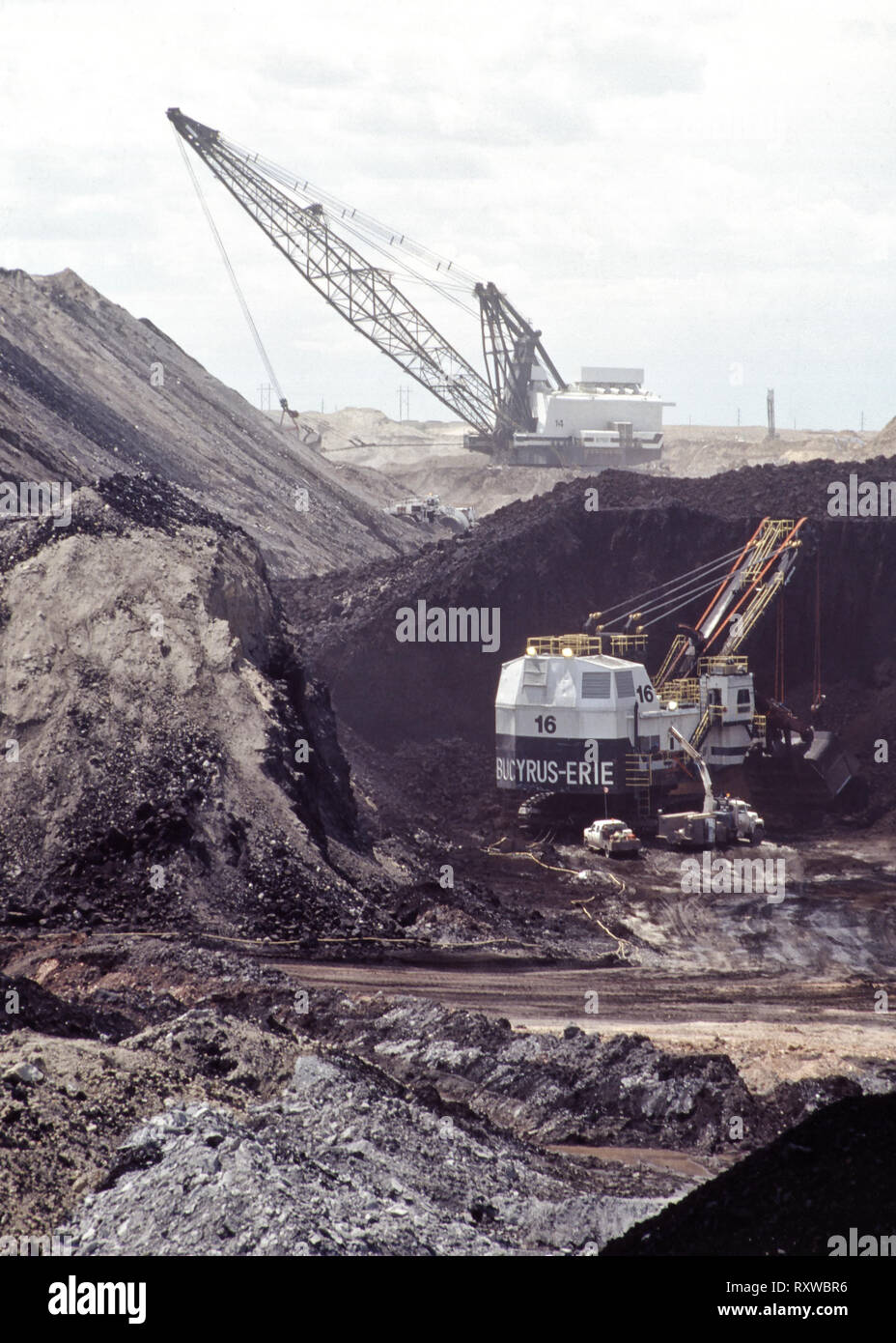 Coal surface mine, Bucyrus Electric Shovel excavating coal seam, shovel working in distance. Stock Photo