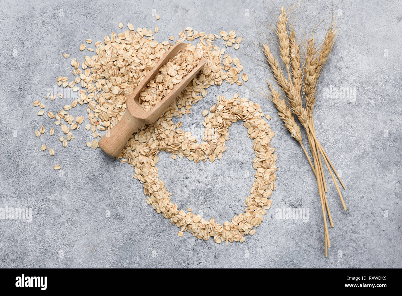Rolled oats, oat flakes on concrete, top view. Healthy food, healthy