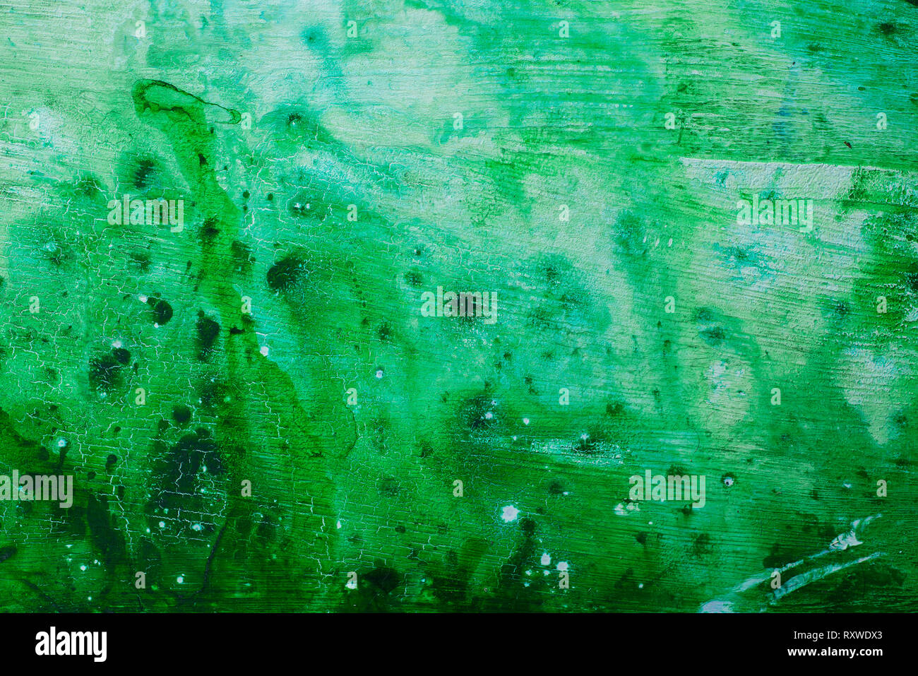 Green watercolor texture on an acrylic base with drips and spots. Spring palette with copy space Stock Photo