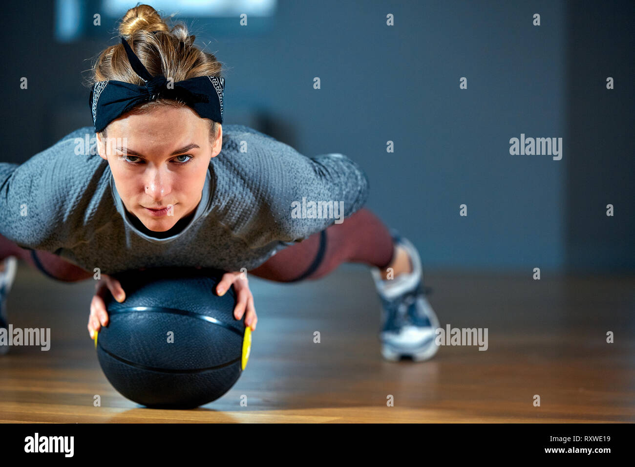 Fit and muscular woman with piercing eyes doing intense core workout