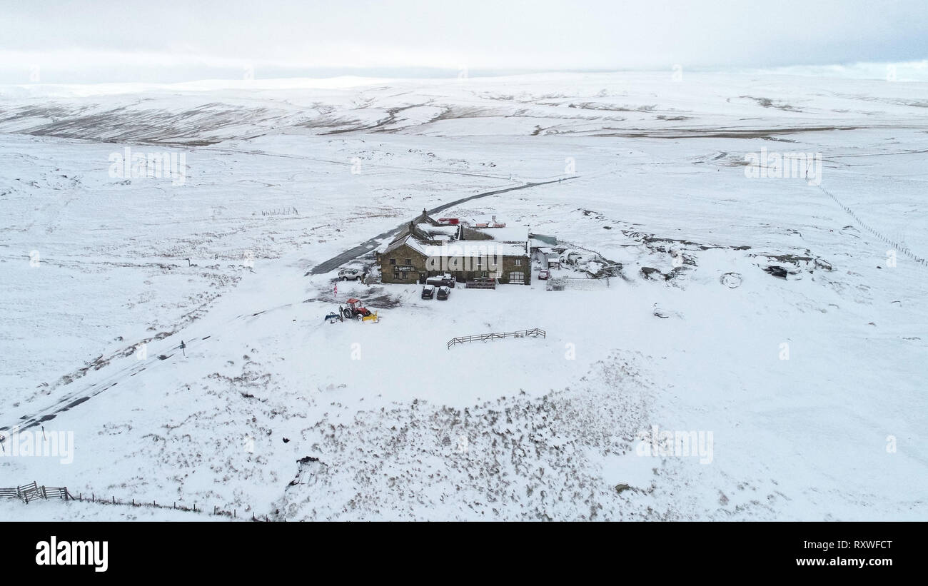 Snow surrounds the Tan Hill pub in North Yorkshire. Stock Photo