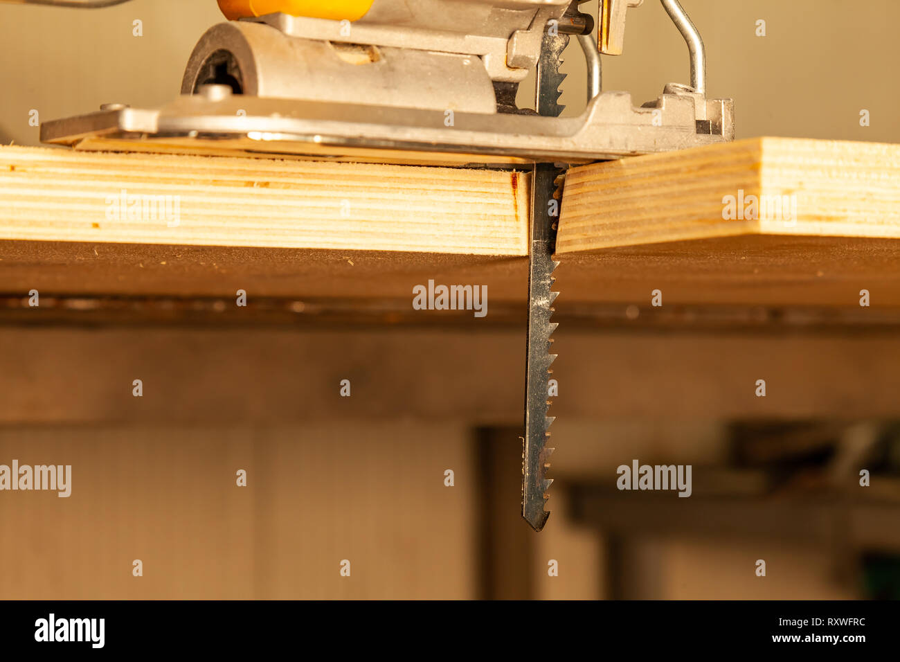 A Yellow Electric Jigsaw Ready For Use Stands In A Sawn Wood