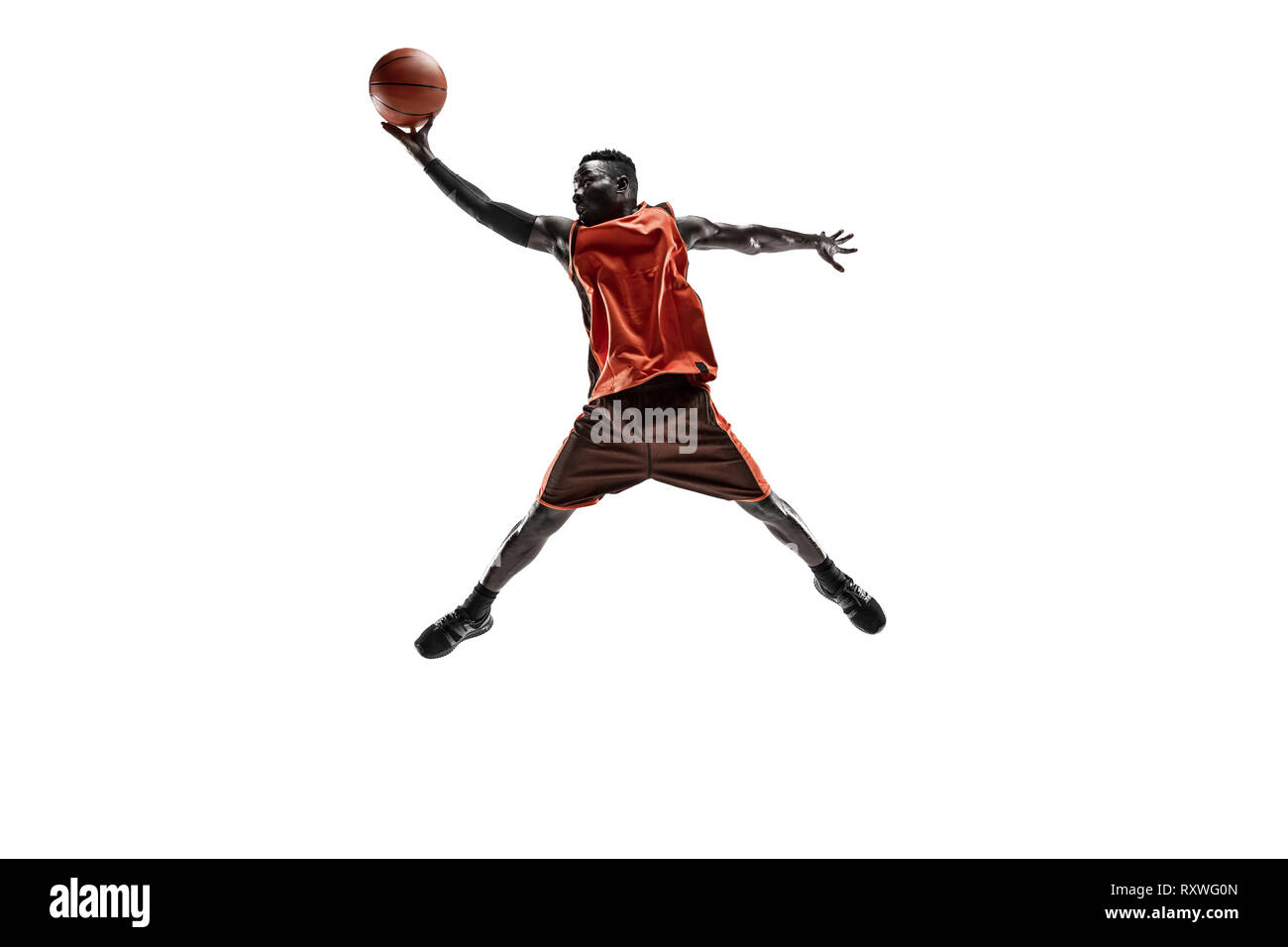 Full length portrait of a basketball player with a ball isolated on
