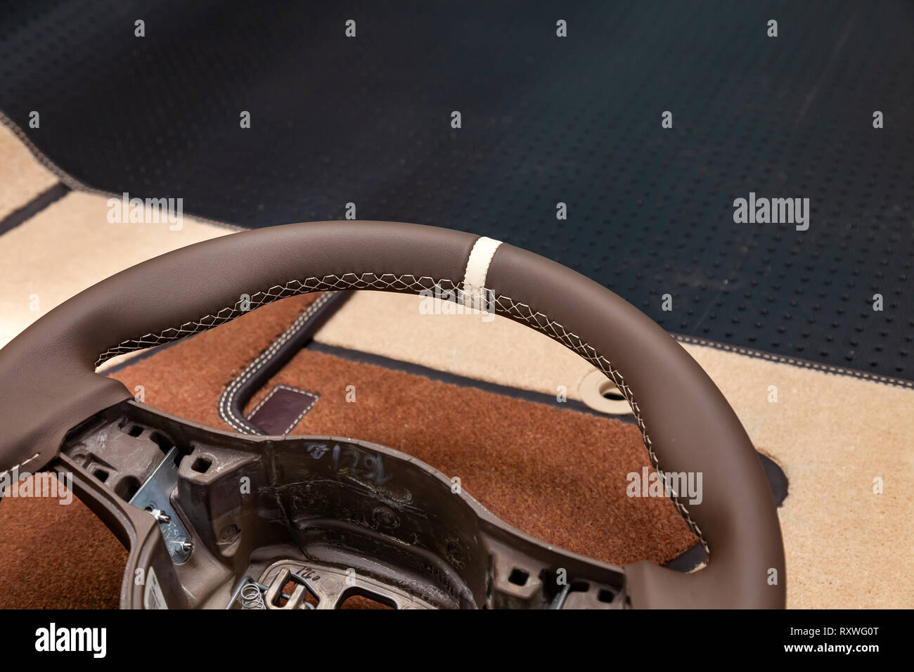 Leather steering wheel brown color in the process of stitching with a