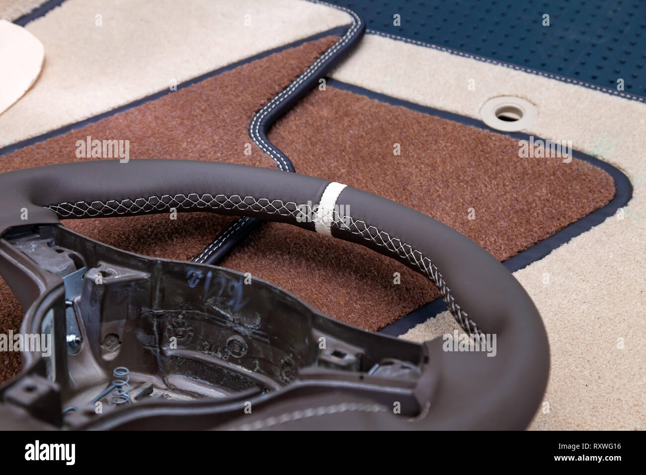 Leather steering wheel brown color in the process of stitching with a