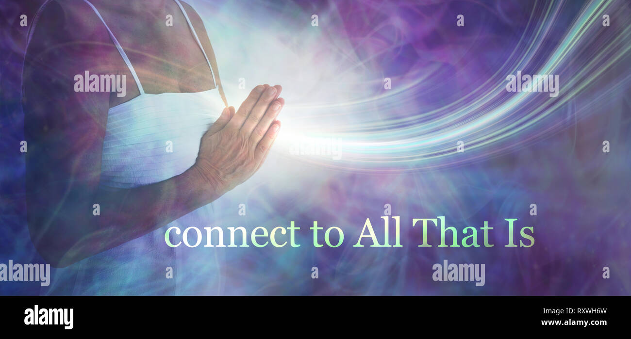 Connect to All that Is - Female torso in white dress with hands in prayer position against ethereal energy field and the words CONNECT TO ALL THAT IS Stock Photo