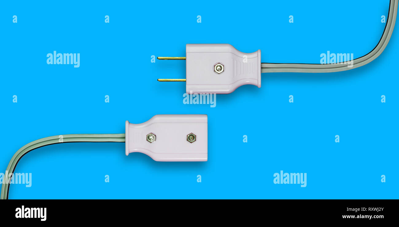 AC power plug with electrical cable on blue background Stock Photo - Alamy