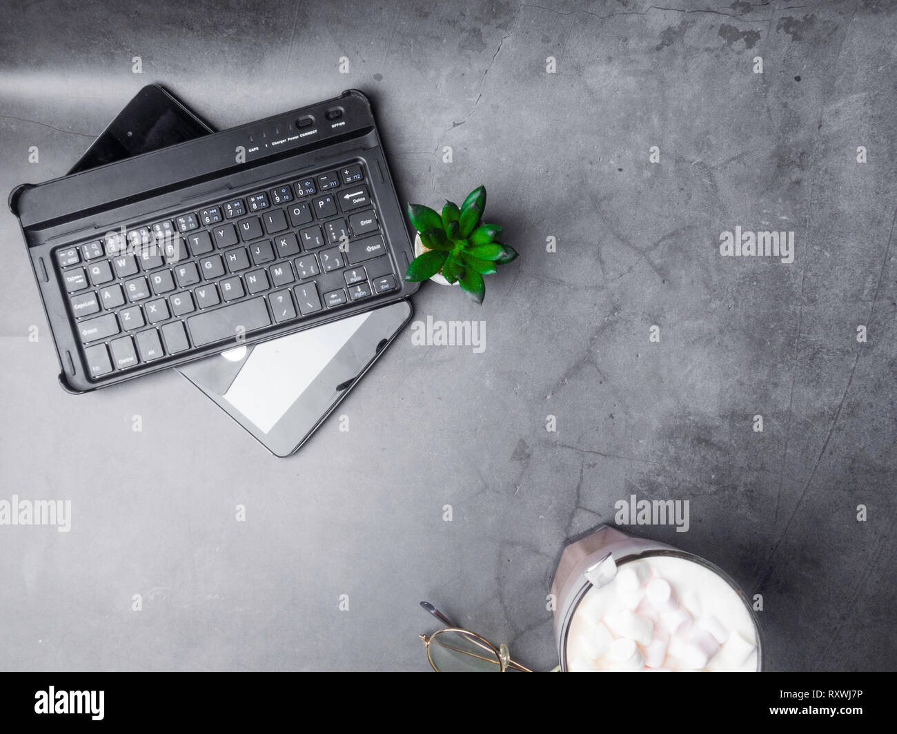 Flat lay, top view office table desk, keyboard, green cactus, master card,  coffee cup on grey background Stock Photo - Alamy