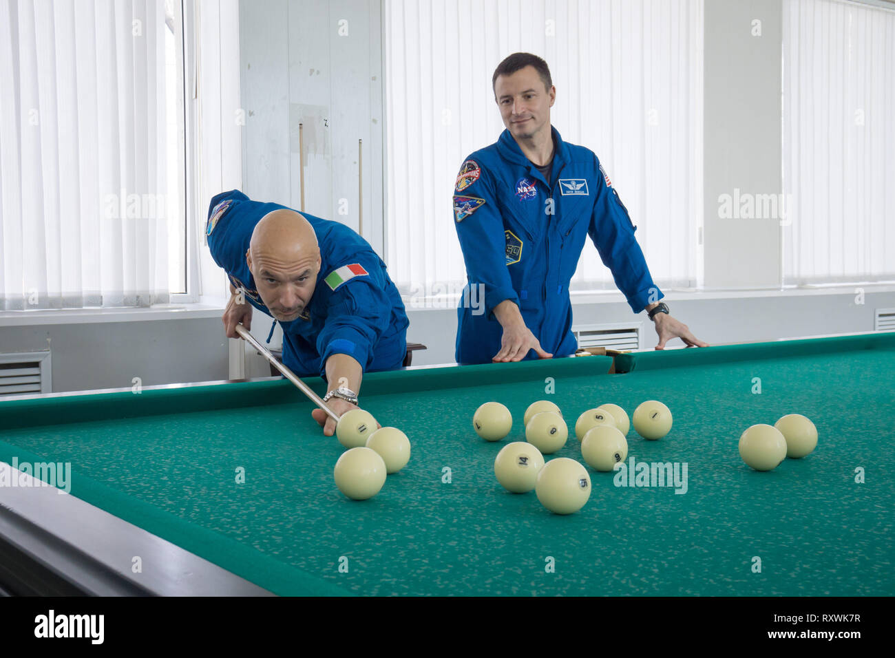 International Space Station Expedition 59 backup crew members Luca Parmitano of the European Space Agency (left) and Drew Morgan of NASA (right) take a moment from pre-launch training for a game of billiards at the Baikonur Cosmodrome March 7, 2019 in Baikonur, Kazakhstan. Expedition 59 crew: Christina Koch of NASA, Alexey Ovchinin of Roscosmos, and Nick Hague of NASA will launch March 14th onboard the Soyuz MS-12 spacecraft for a six-and-a-half month mission on the International Space Station. Stock Photo
