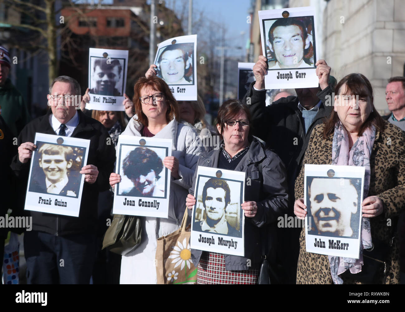 Family members hold images of those who died in disputed circumstance