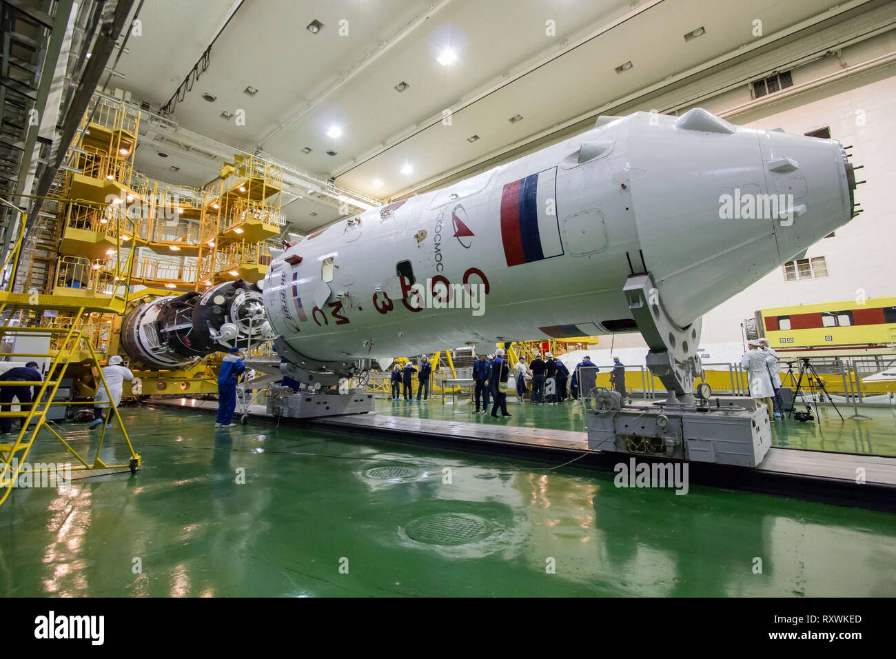 The Russian Soyuz MS-12 spacecraft is encapsulation into the nose fairing of the booster rocket in the Integration Building at the Baikonur Cosmodrome March 6, 2019 in Baikonur, Kazakhstan. The Expedition 59 crew: Nick Hague and Christina Koch of NASA and Alexey Ovchinin of Roscosmos will launch March 14th for a six-and-a-half month mission on the International Space Station. Stock Photo