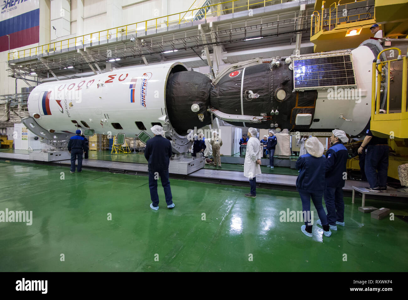 The Russian Soyuz MS-12 spacecraft is encapsulation into the nose fairing of the booster rocket in the Integration Building at the Baikonur Cosmodrome March 6, 2019 in Baikonur, Kazakhstan. The Expedition 59 crew: Nick Hague and Christina Koch of NASA and Alexey Ovchinin of Roscosmos will launch March 14th for a six-and-a-half month mission on the International Space Station. Stock Photo