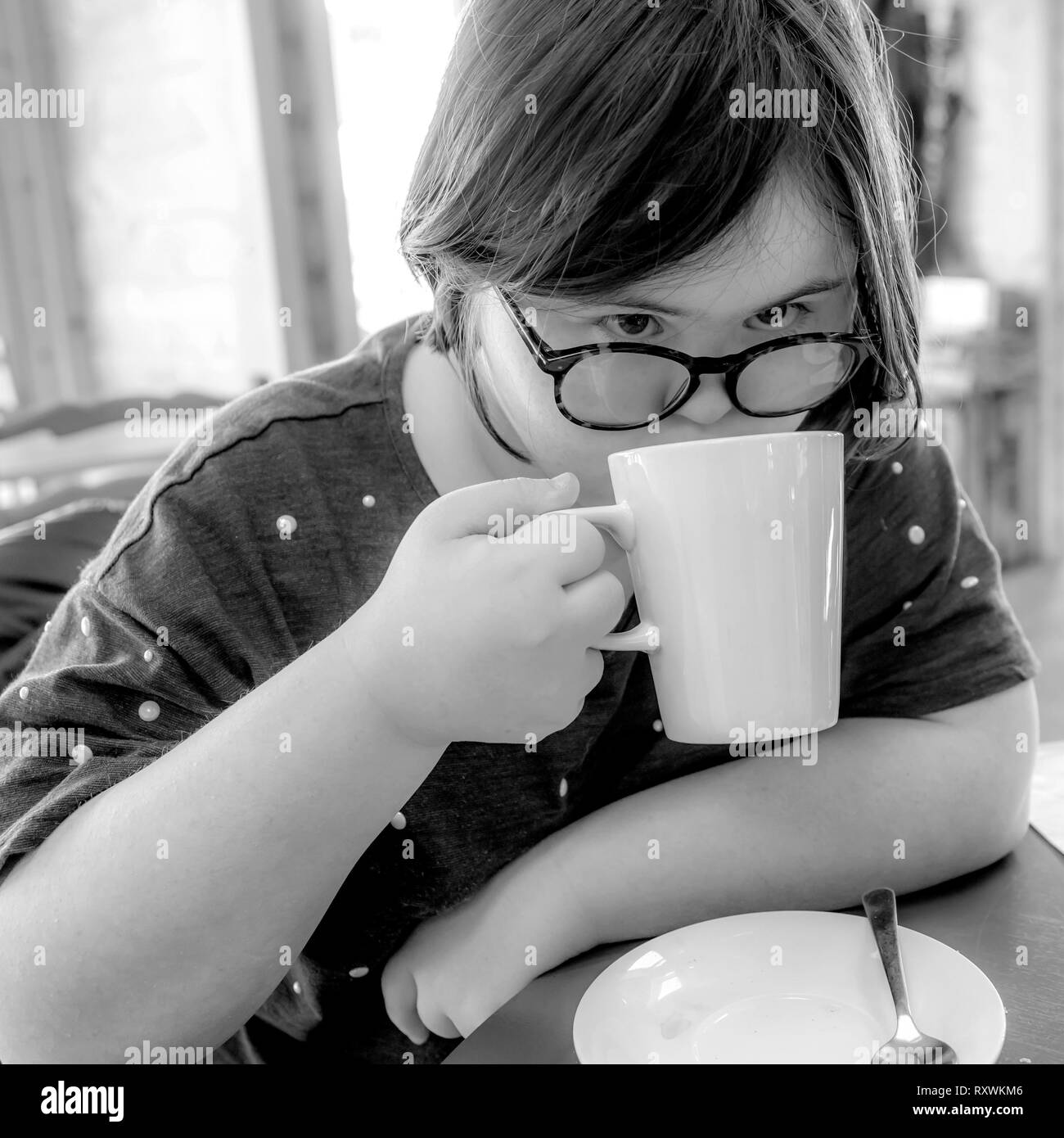 Young girl with Downs Syndrome having afternoon tea at White Mill Mariana, Northamptonshire. Stock Photo