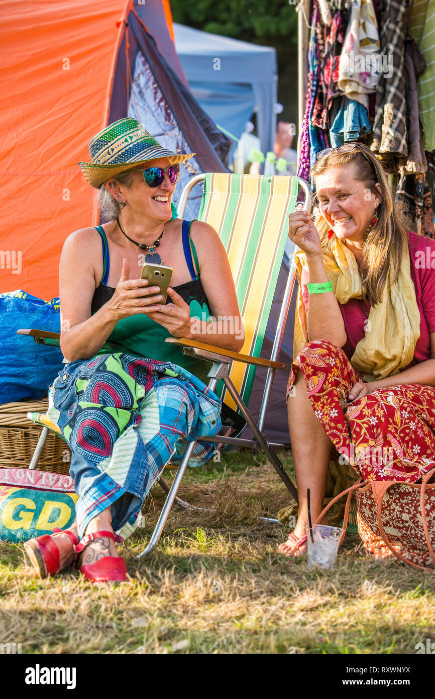 Two ladies having a laugh at Into the Wild festival, Kent, UK Stock 