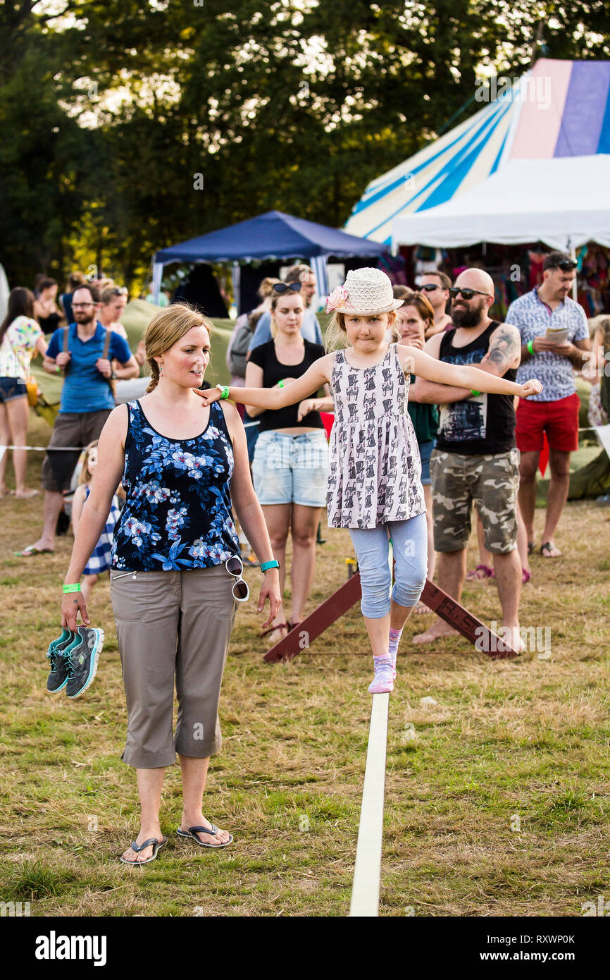 Kids tightrope walking circus workshop at Into the Wild festival, Kent, UK Stock Photo