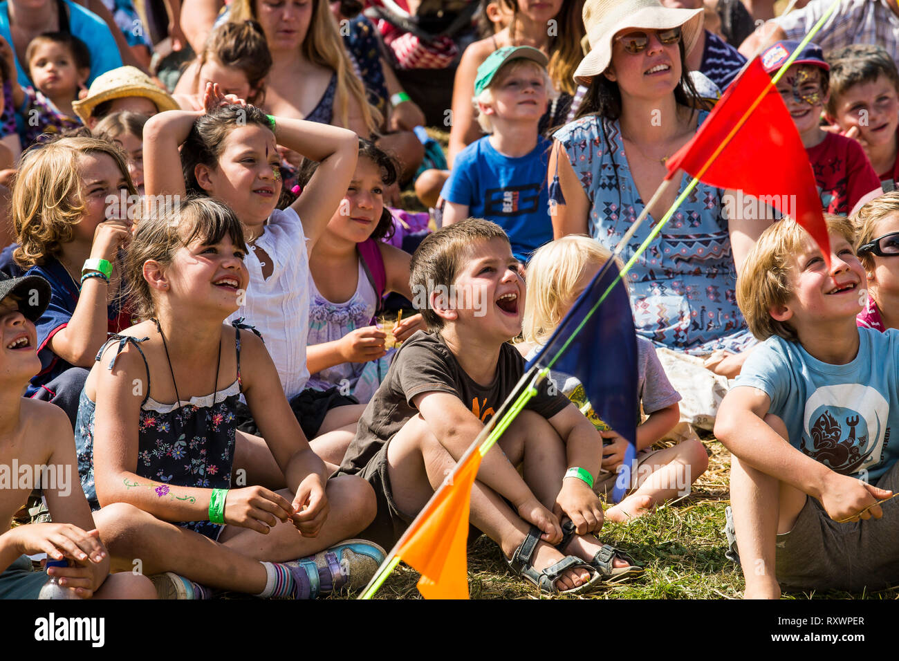 Large group of children enjoying a show at Into the Wild festival, Kent, UK Stock Photo