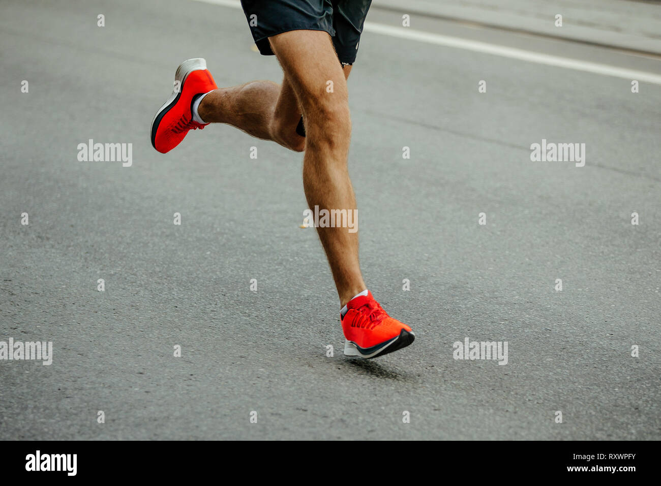 legs man runner in bright red shoes running on asphalt Stock Photo Alamy