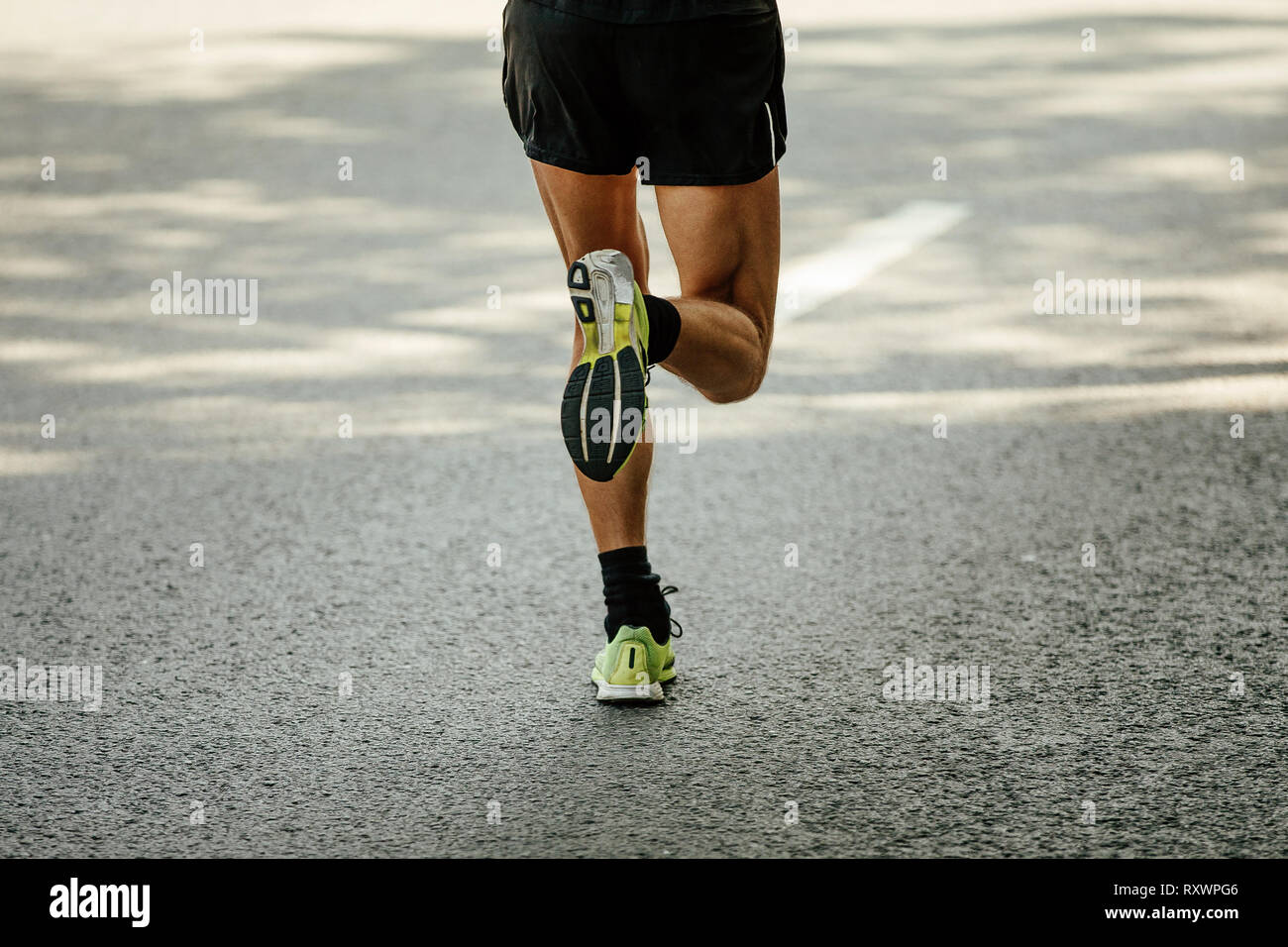 back legs male runner running on gray asphalt Stock Photo