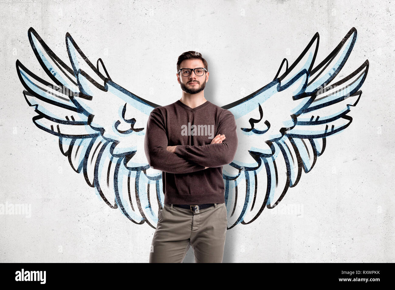 Man with glasses wearing casual clothes with wings drawn on the wall on the  background Stock Photo - Alamy
