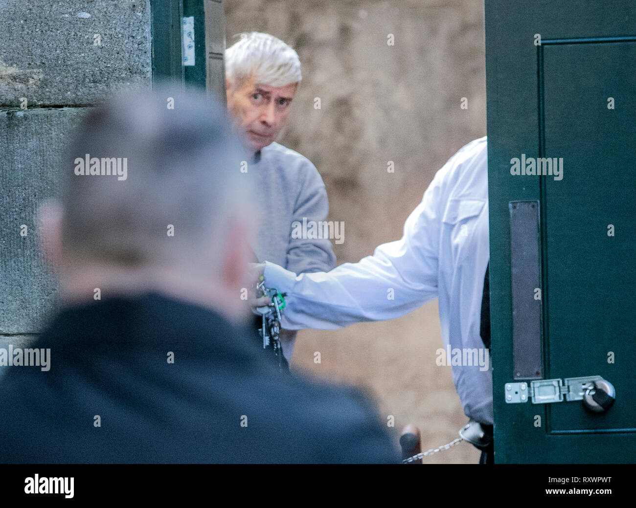 Geoffrey Crossland is lead away in handcuffs to a prison van after being jailed for more than 12 years at York Crown Court, he amassed one of the largest known hauls of indecent images in England and Wales. Stock Photo